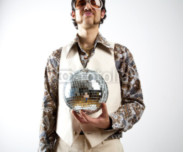 Fototapety Portrait of a retro man in a 1970s leisure suit and sunglasses holding a disco ball - mirror ball