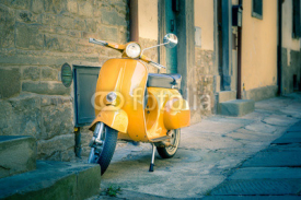 Naklejki Yellow scooter in tuscan Cortona town